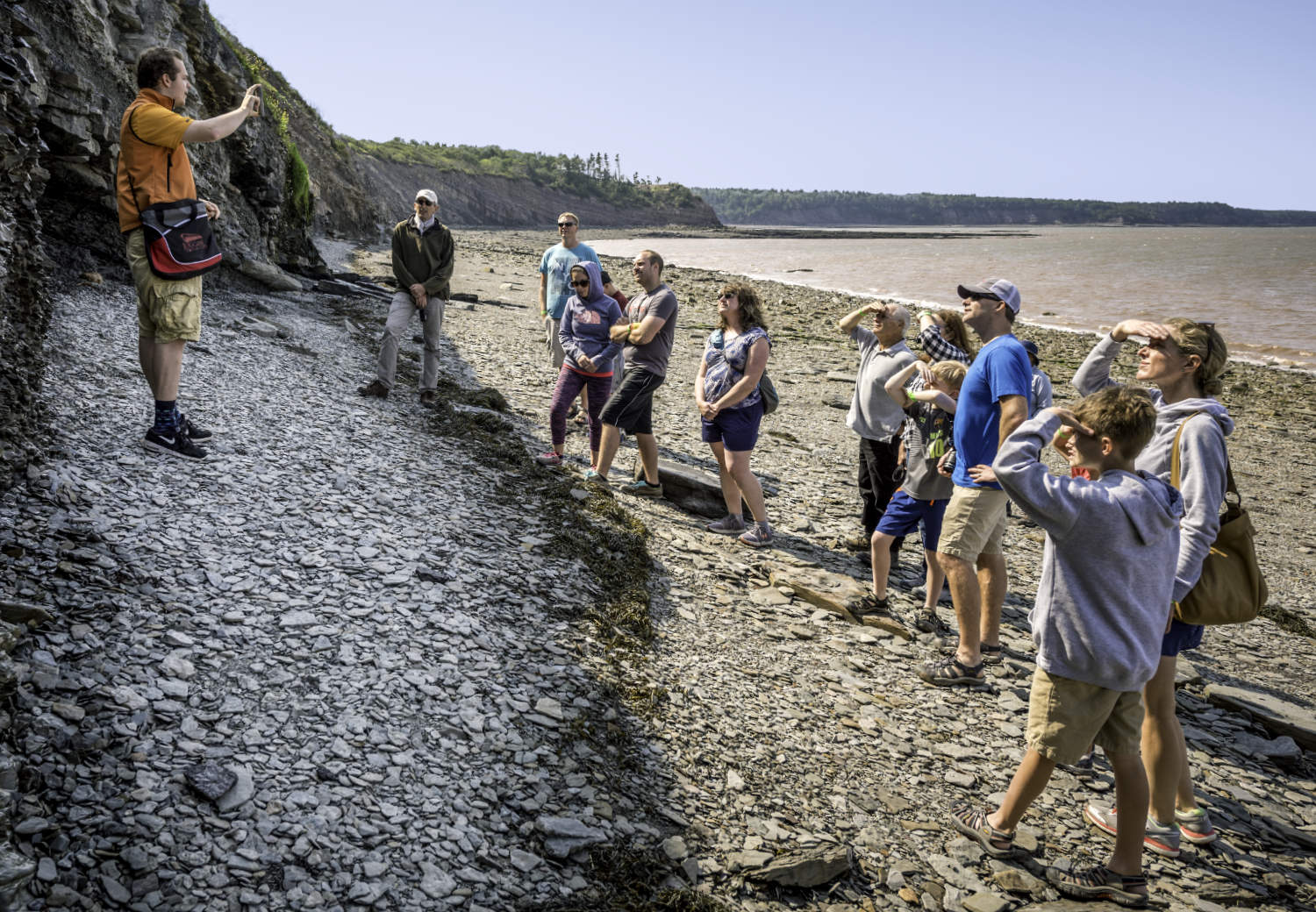 A tour guide leading a group on the beach at the cliffs at Joggins, Nova Scotia